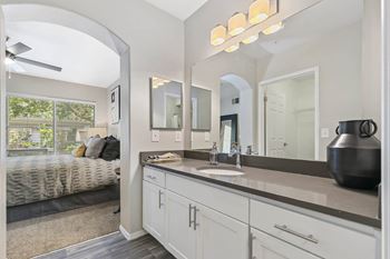 a white bathroom with a large mirror and a sink at Ascent Apartments, Cottonwood Heights, UT 84121